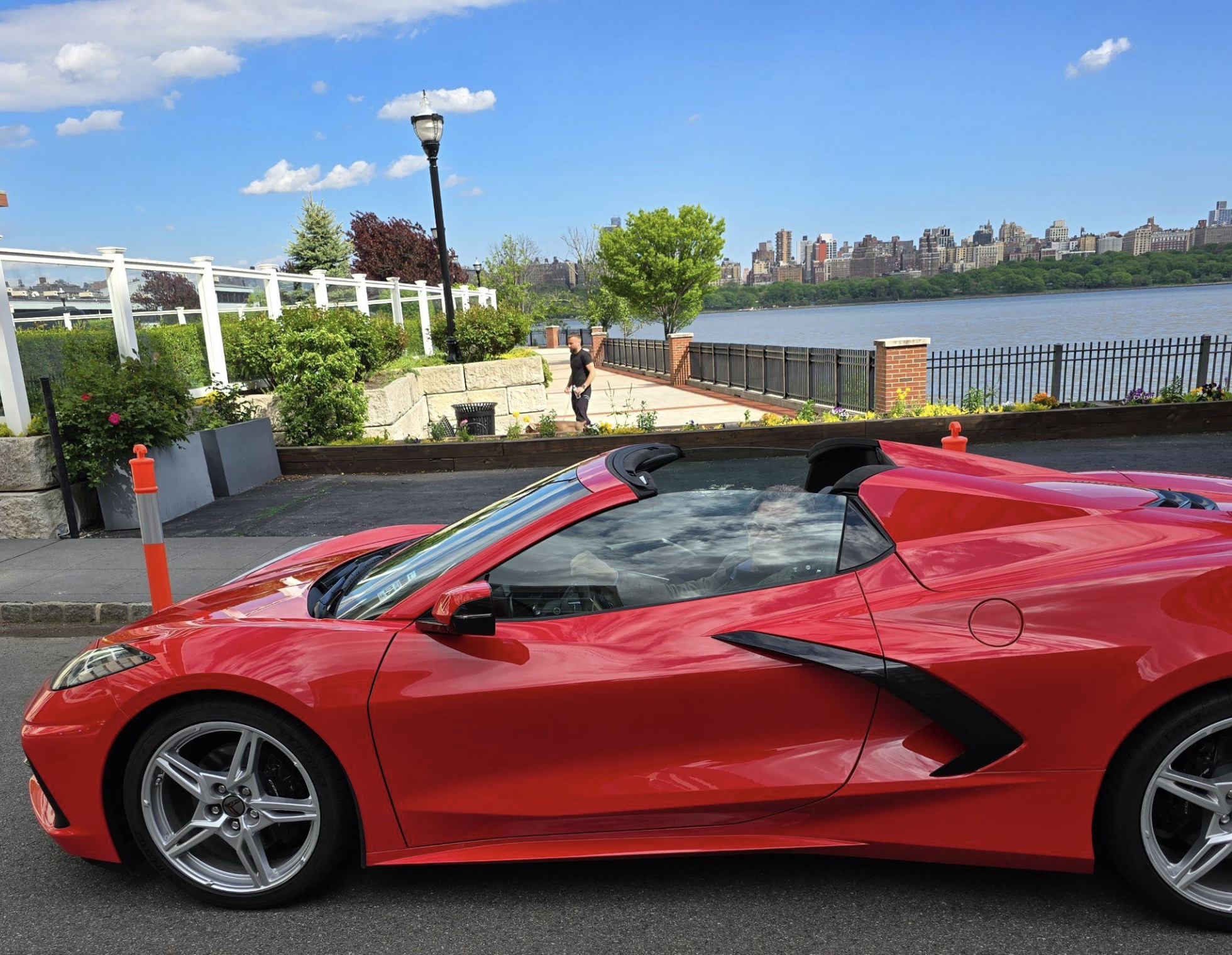 Red Corvette parked on a street near a river, symbolizing freedom and new perspectives in later life.